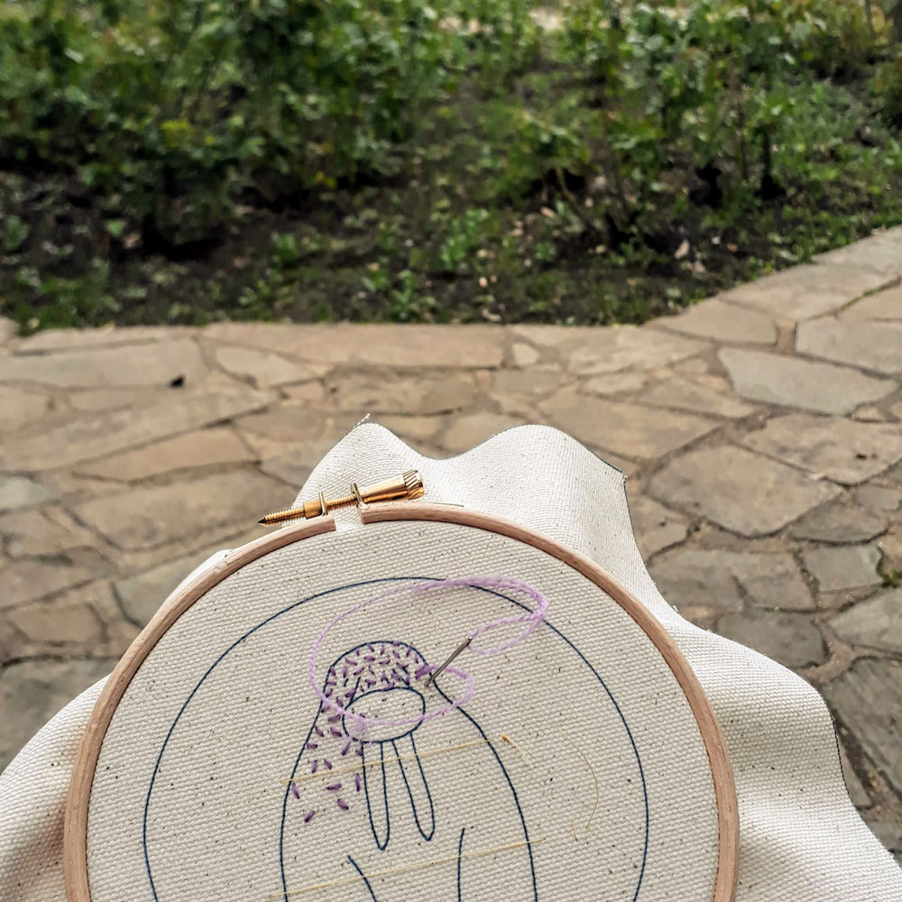 Stitching a walrus embroidery in the park.