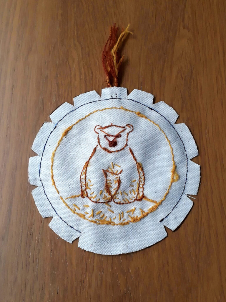 A circular ornament sewn up with right sides together, notches have been cut into the seam allowance at regular intervals.