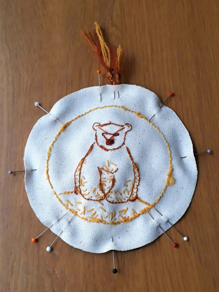 Circular ornament pinned together ready for sewing. Double pins mark where to start and end stitching.