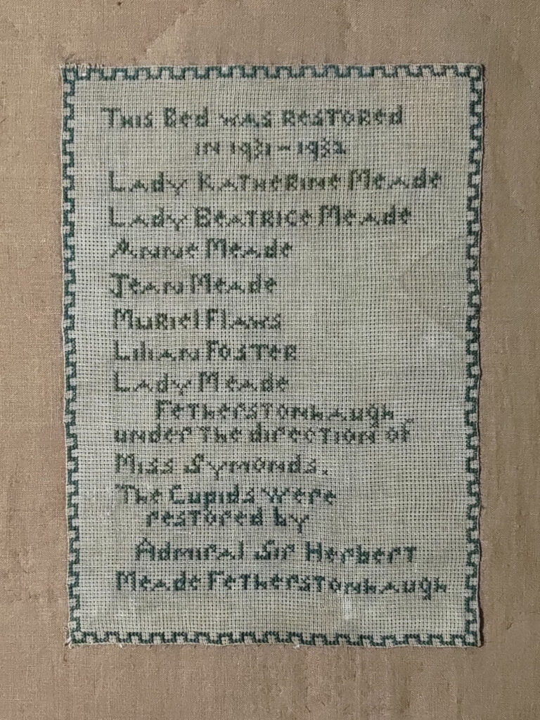 Rectangle of canvas on which the names of the people who worked on restoring the bed in 1931-2 are stitched.