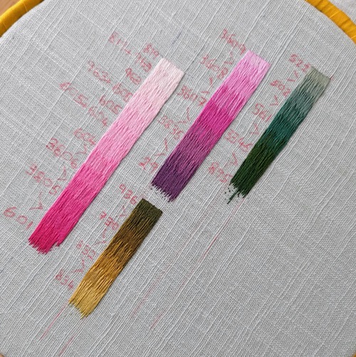 Four bars of long and short stitch showing different gradients of colour. On the left, pale to dark pink, in the middle pink to dark purple, below dark muddy green to gold, on the right light to dark green.