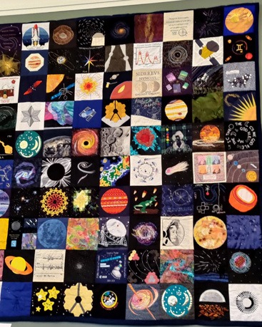 Patchwork quilt made up of a number of different square astronomical designs.