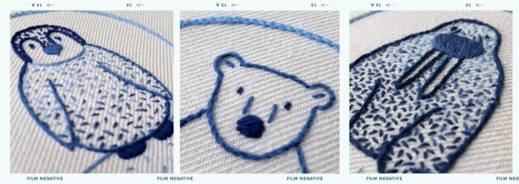 3 photos of completed embroiders stitched in shades of blue. From left to right: A penguin chick, close up of a polar bear face, a walrus.