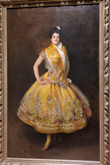 Painting of a white woman wearing a sleeveless gold dress with wide skirt.