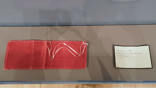 A rectangle of red velvet fabric on the left and a hand written note on the right.