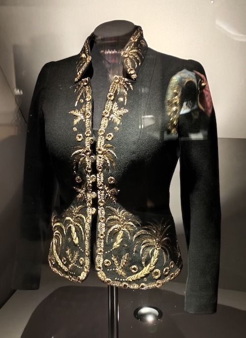 Black jacket with a palm tree design around the collar, front and bottom in goldwork embroidery.